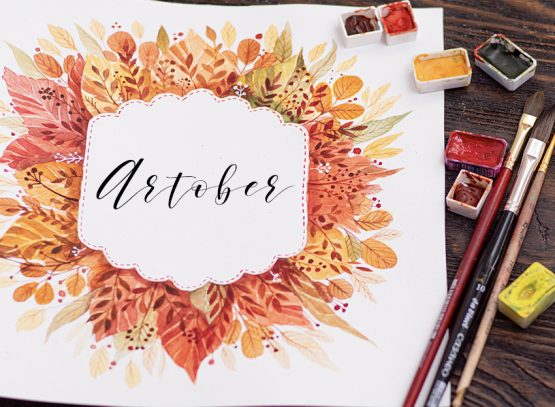 The Leigh Way, LLC | Artober header with watercolor fall leaves and paintbrushes on a wooden table top.