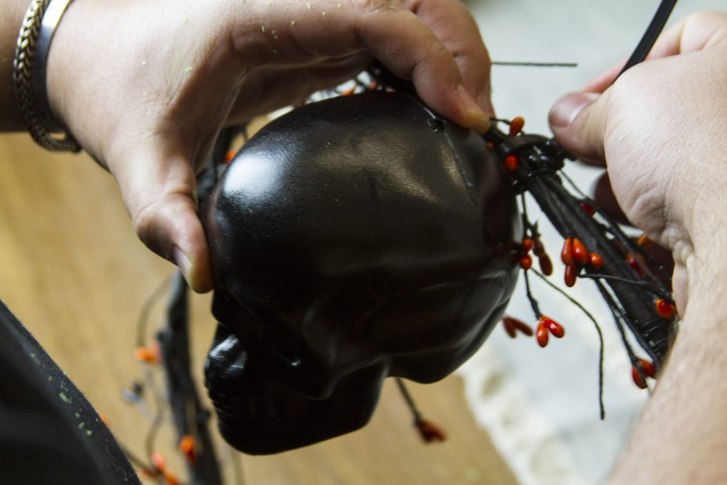 tightning the zip tie to the wreath
